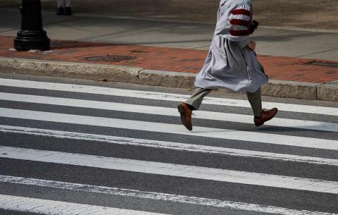 PhD running across crosswalk
