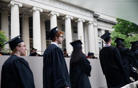 Image of students in front of Building 10 waiting to receive their Congratulations scroll